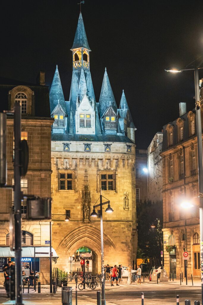 A beautifully illuminated Porte Cailhau in Bordeaux captures the essence of its Gothic architecture at night.